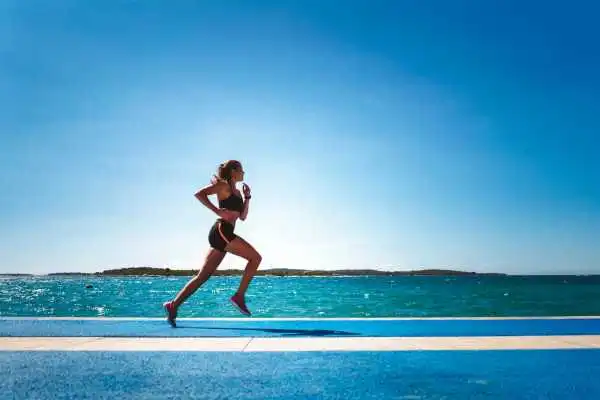 Woman running showing strong leg muscle Lincolnshire